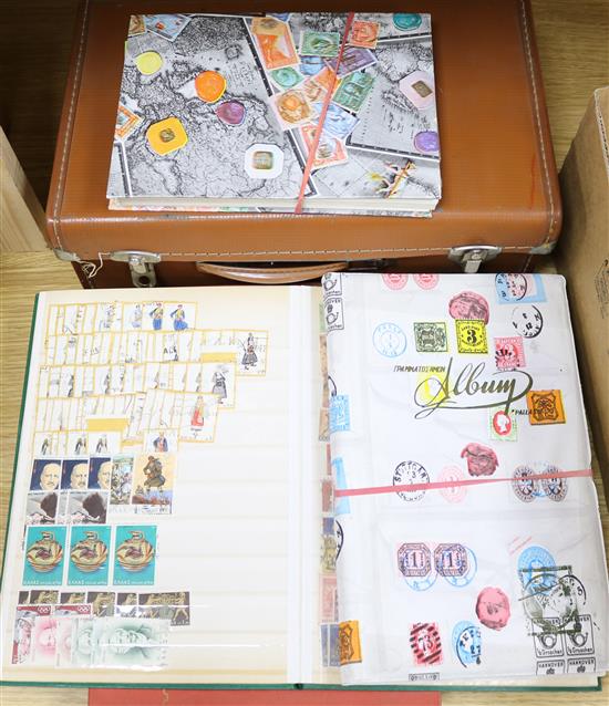 A suitcase of loose stamps and five albums of stamps